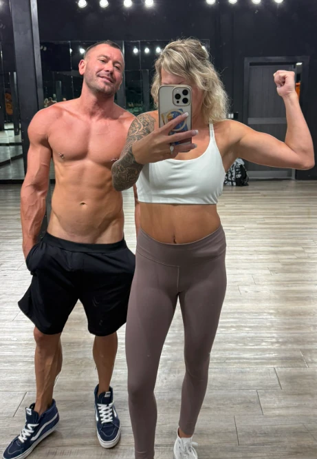 Chris and Candice Coxx taking a gym mirror selfie, the Kink Life Couple