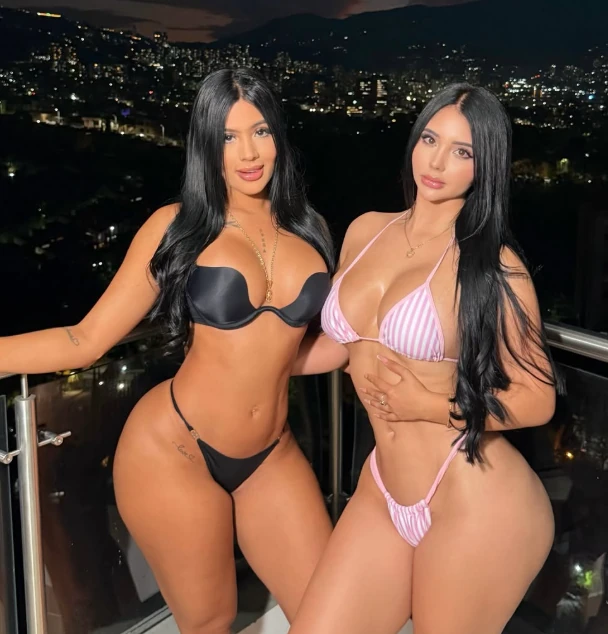 Gemelas Abello, the Colombian OnlyFans twins, on a balcony above Medellin at night