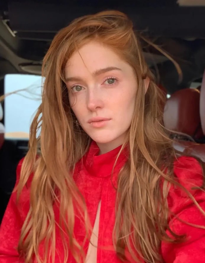 Jia Lissa, a red-haired lesbian OnlyFans star, in a red top