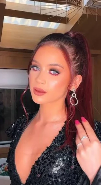 Nicoly Rio with red hair in a sequinned top, a Rio de Janeiro OnlyFans couple creator